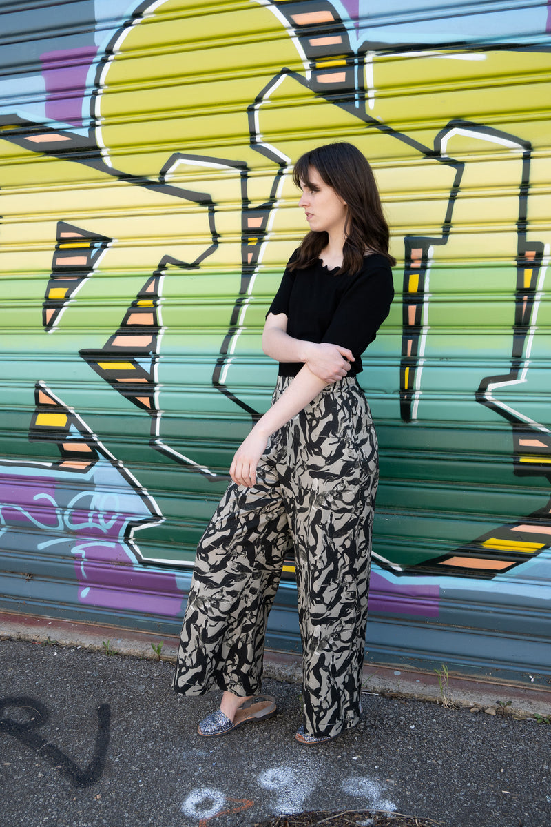 Grey wide legged pants with black silhouette mermaids